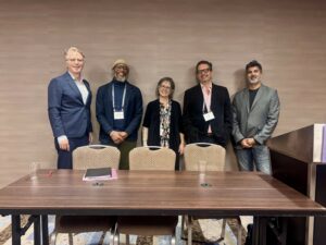Panelists Richard Ashby Wilson, Jeffrey Omari, Pablo Rueda-Saiz, and Riaz Tejani gather with Elizabeth Mertz following a roundtable at the 2025 Law and Society Association meeting.